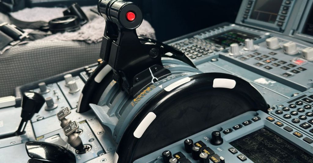 Detailed view of aircraft cockpit controls and instrumentation panels in an airplane.
